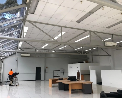 Building Interior Shiny White Space With 2 People Working