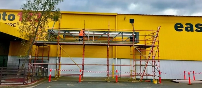 Campis Worker on Scaffolding Building Maintenance Service