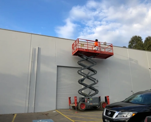 Crane With a Person on a Building